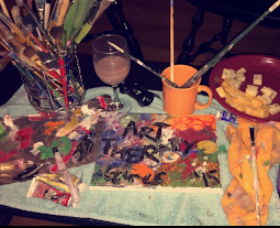 art supplies, food, an painting on table