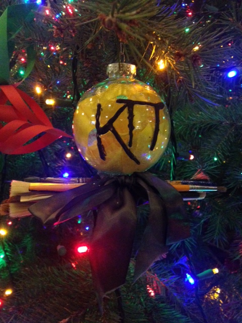 Zeta Omicron Christmas Ornament with a bow and paintbrushes
