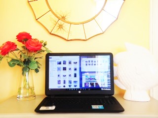 laptop on desk in yellow rooms with red flowers