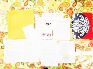papers laid out on a yellow bedspread
