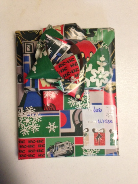 gift wrapped in stars wars Christmas paper with handmade bow