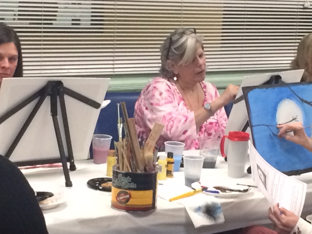 woman painting at the senior center