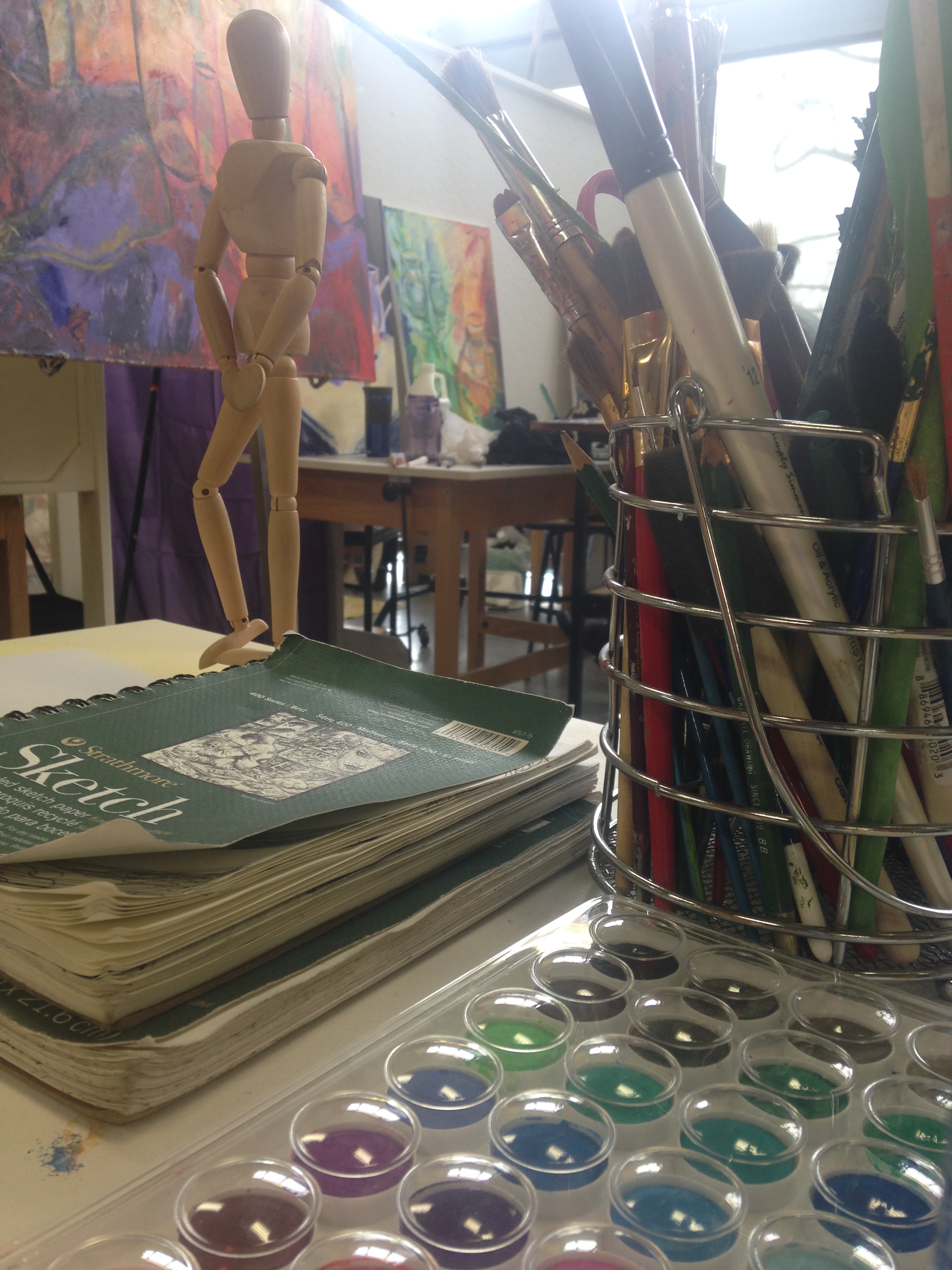 a desk of art supplies