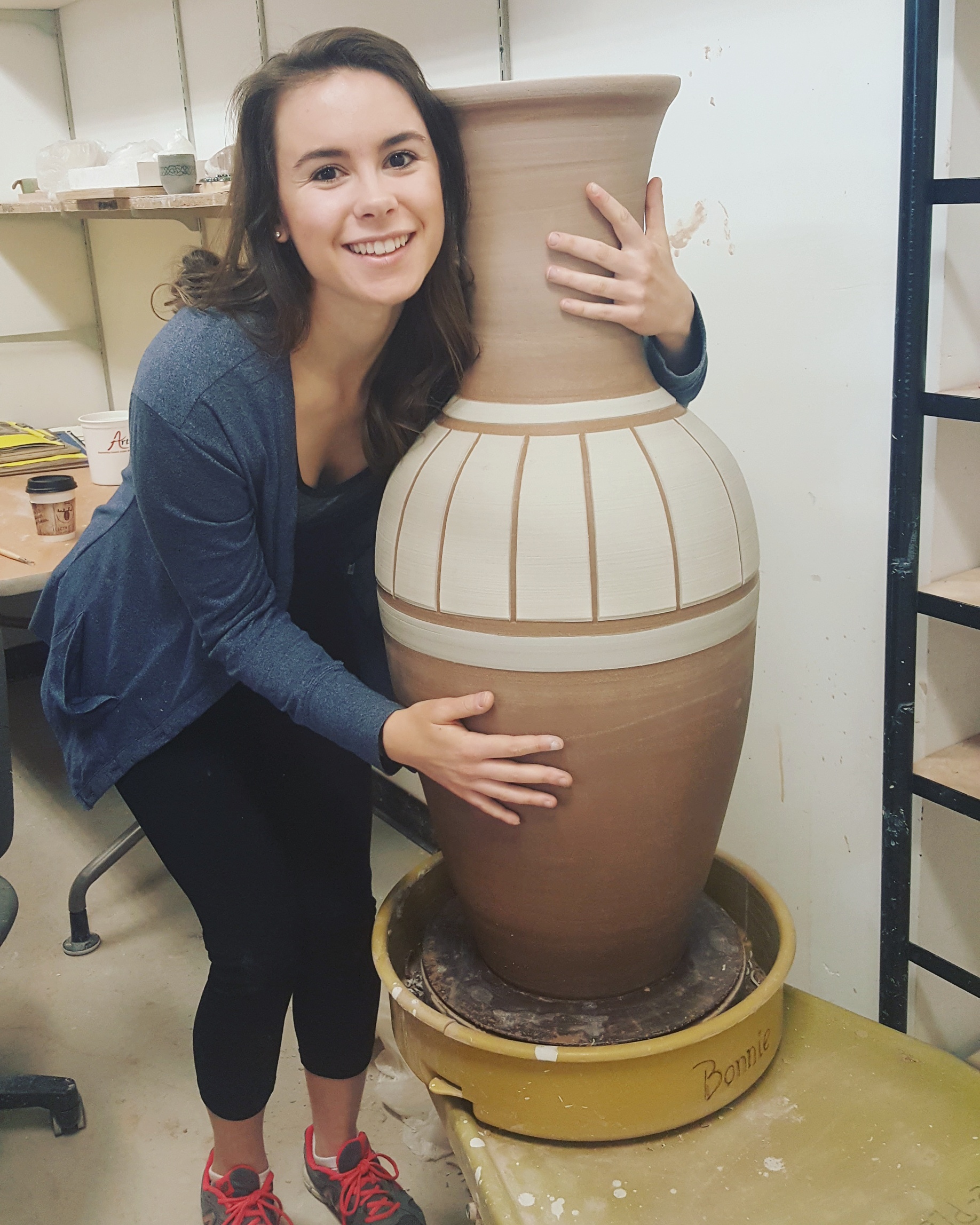 Picture of Emma holding her artwork