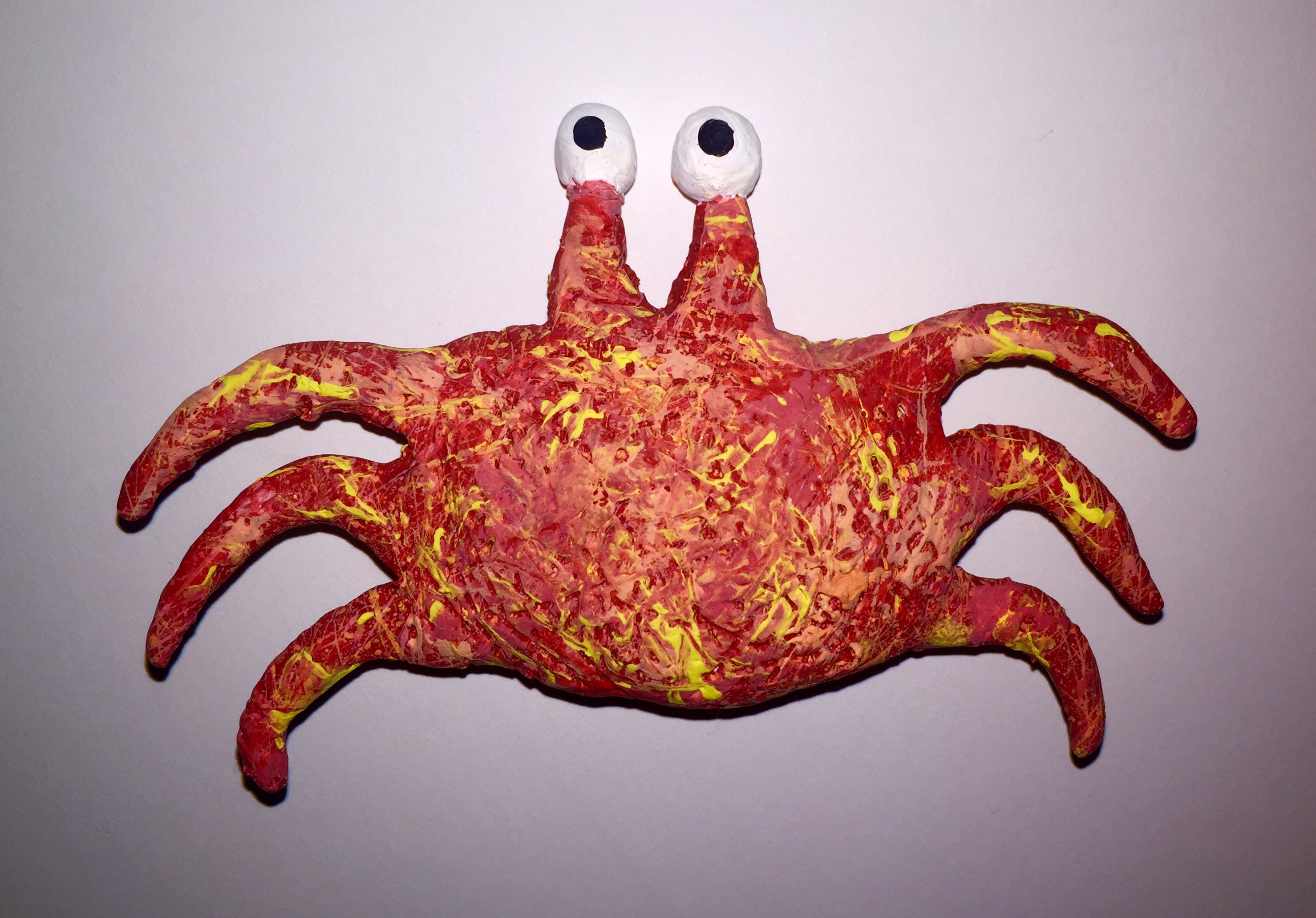 Clay crab covered in splattered paint