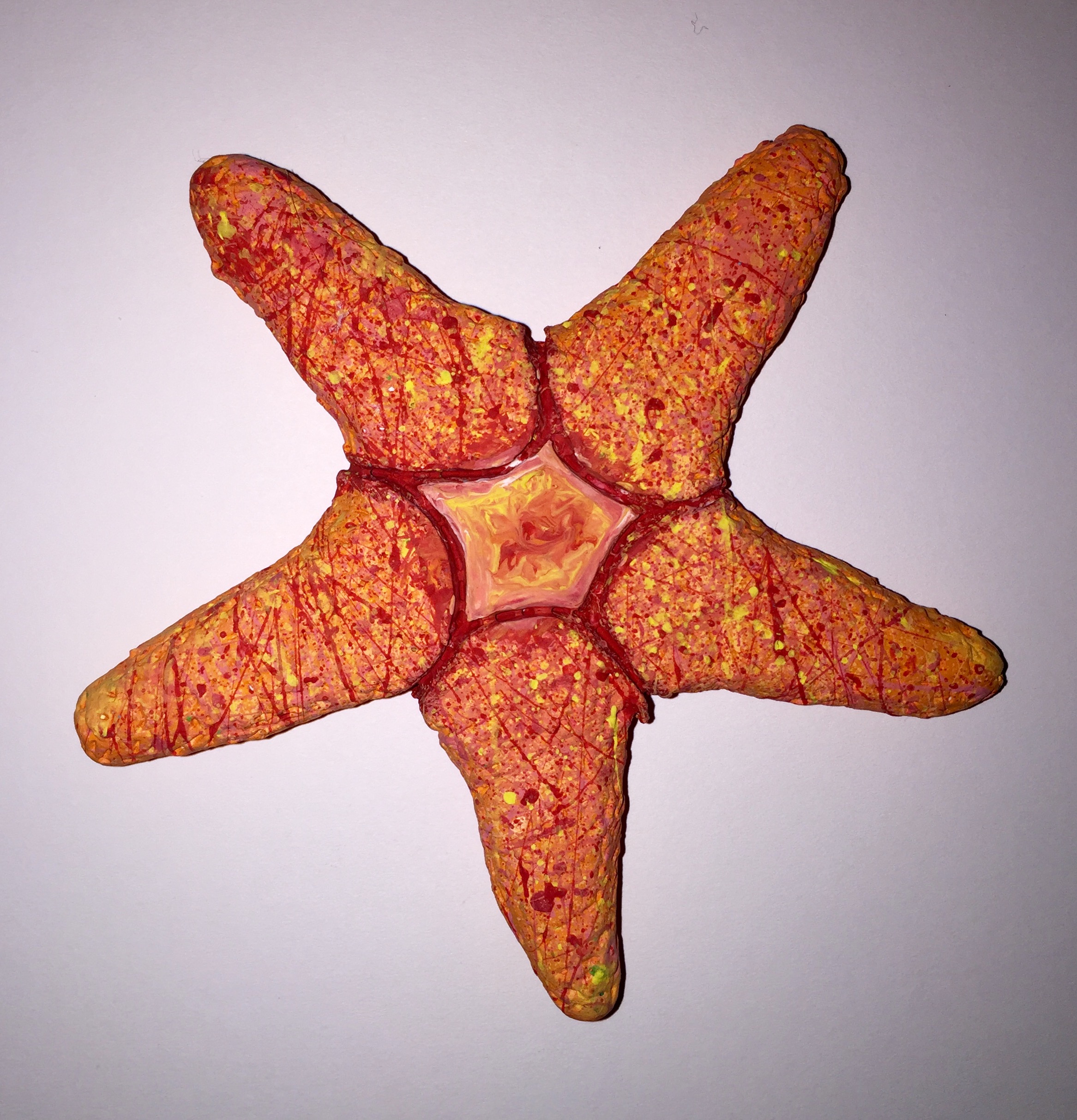Clay starfish covered in splattered paint