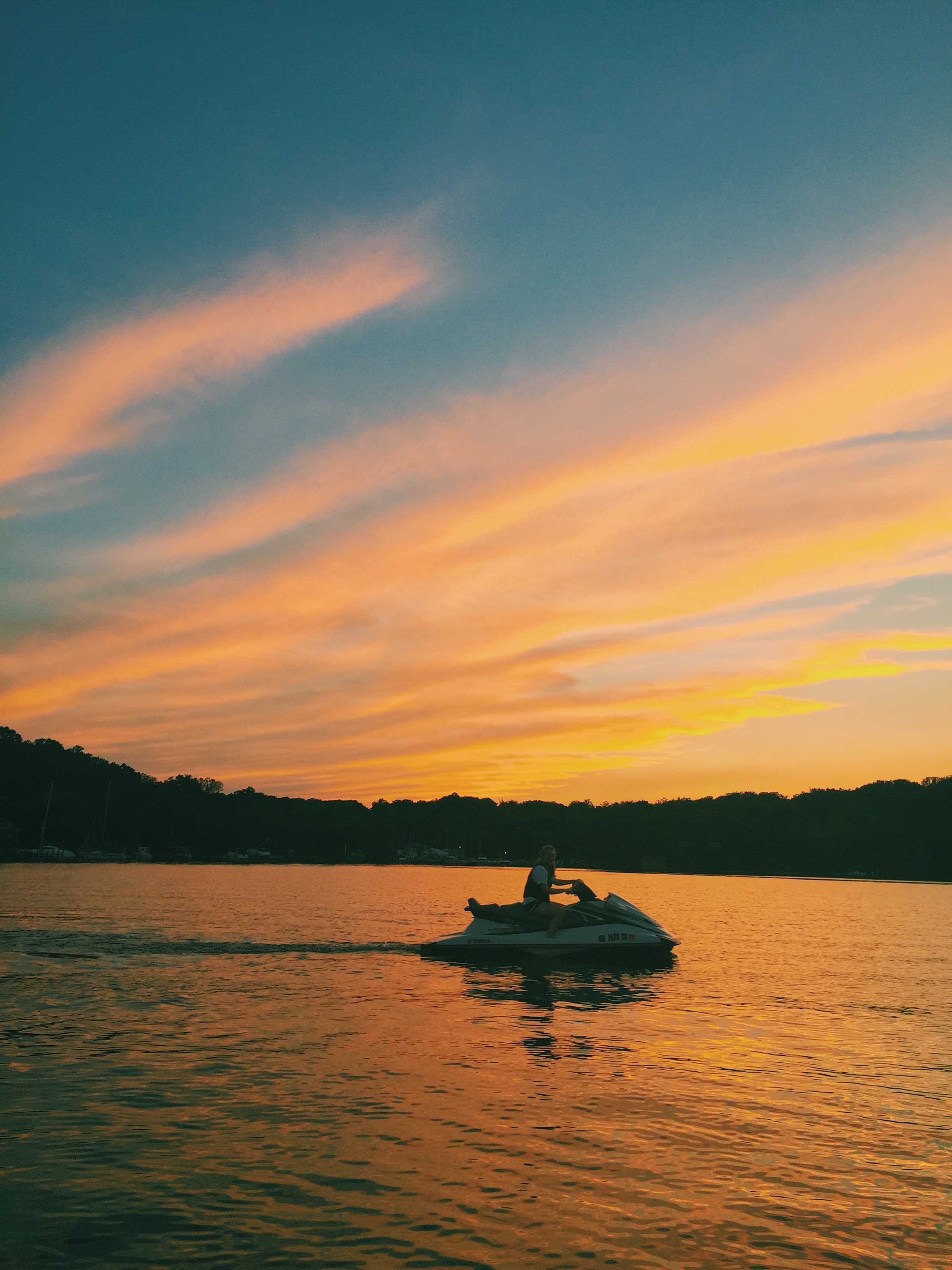 Girl on jetski with sunset in the background