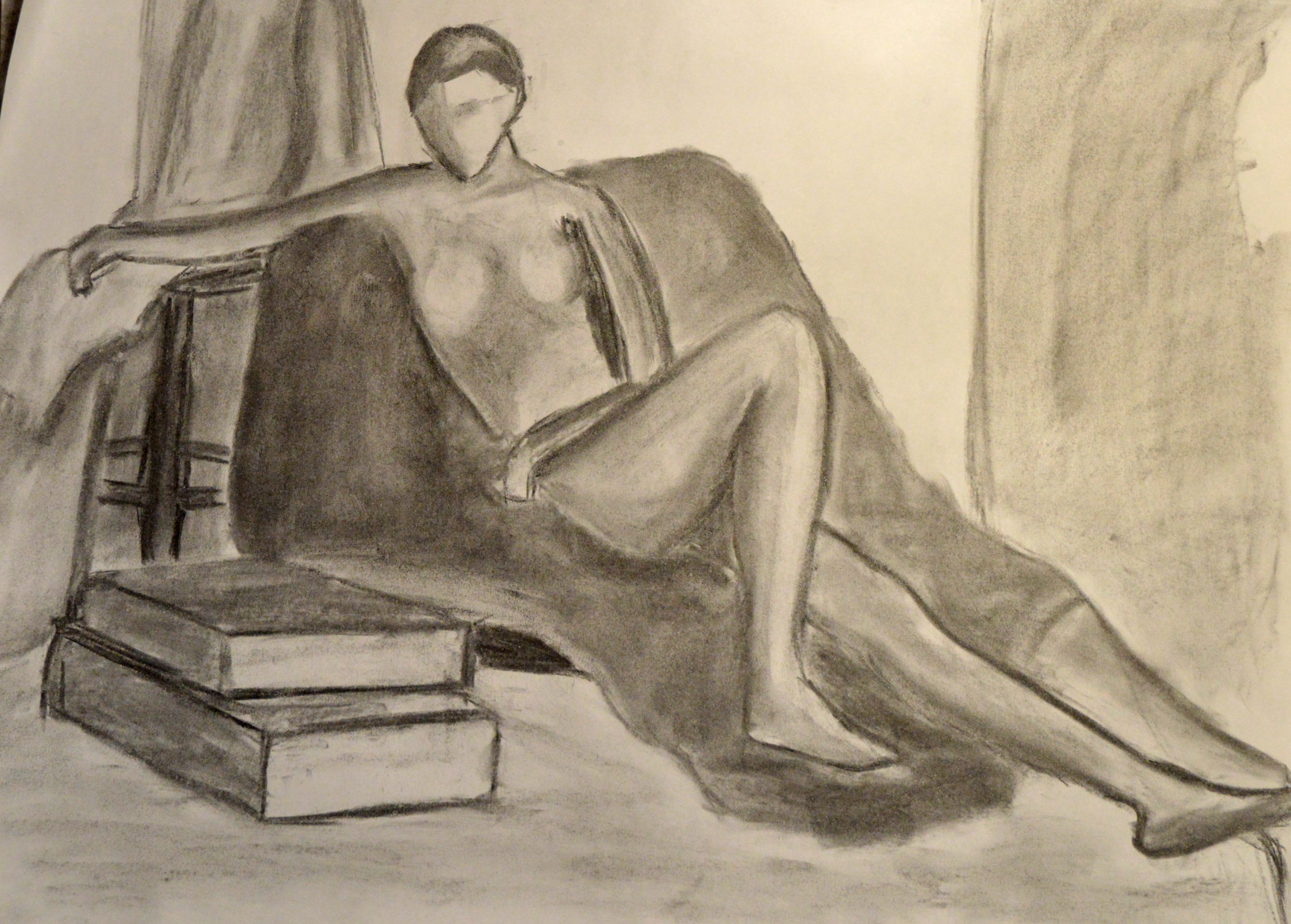 Charcoal drawing. Figure reclining on fabric