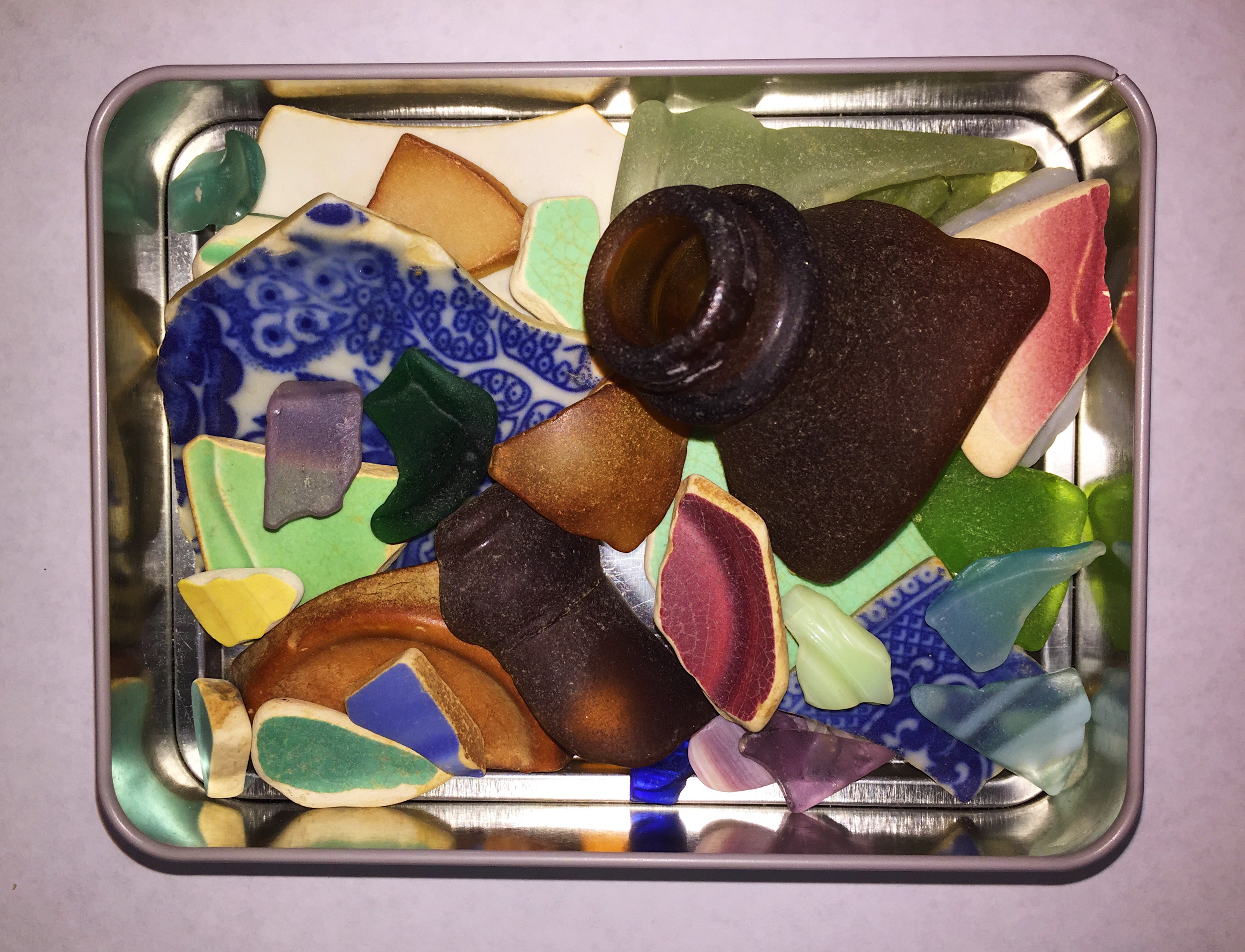 colorful sea glass in a metal container