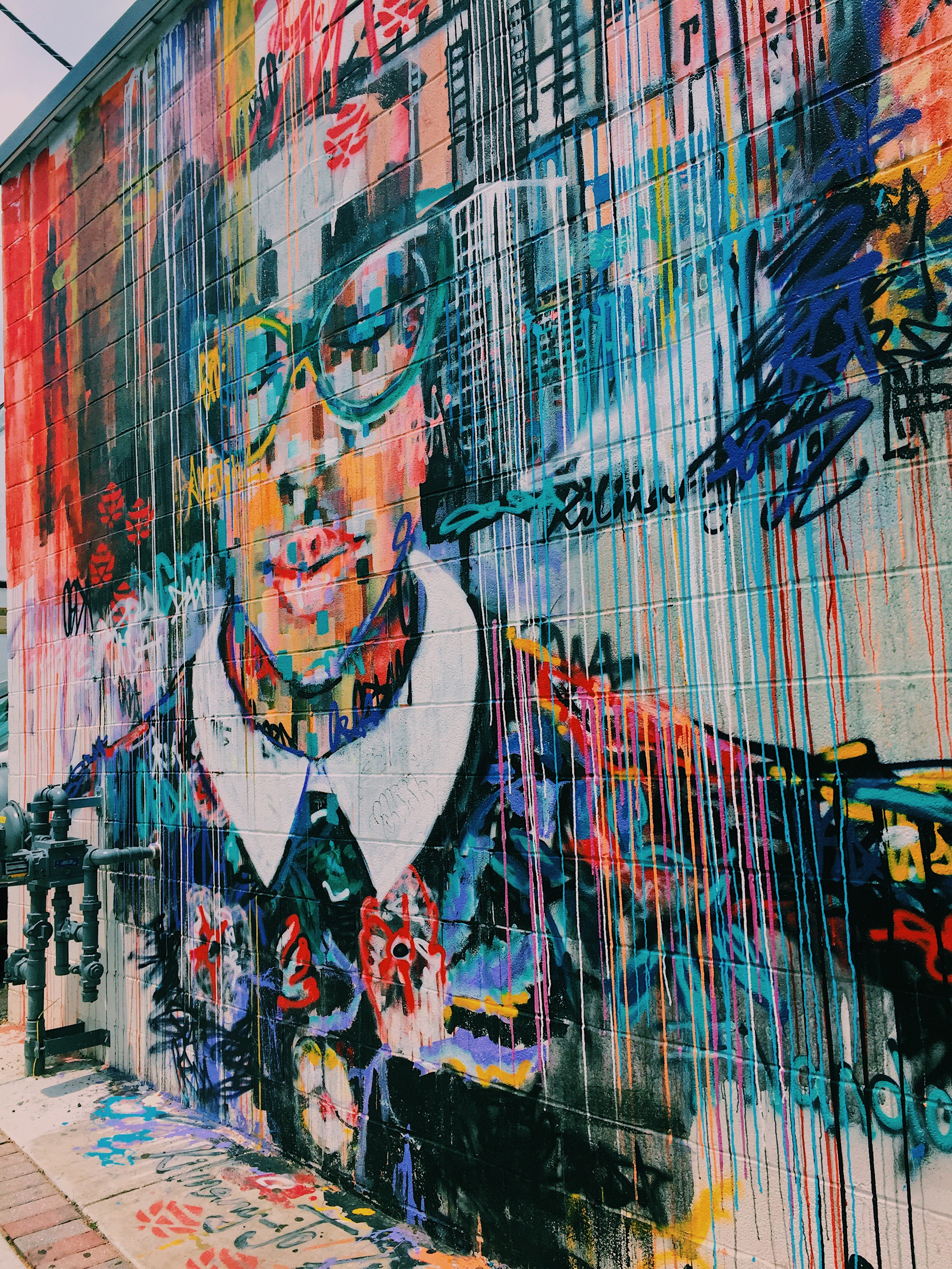 Colorful mural of a girls face and dripping paint