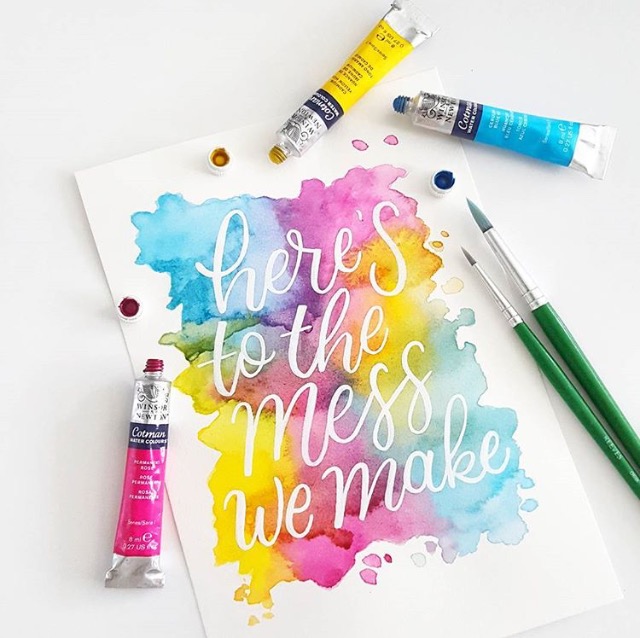 "heres to the mess we make" with watercolor background