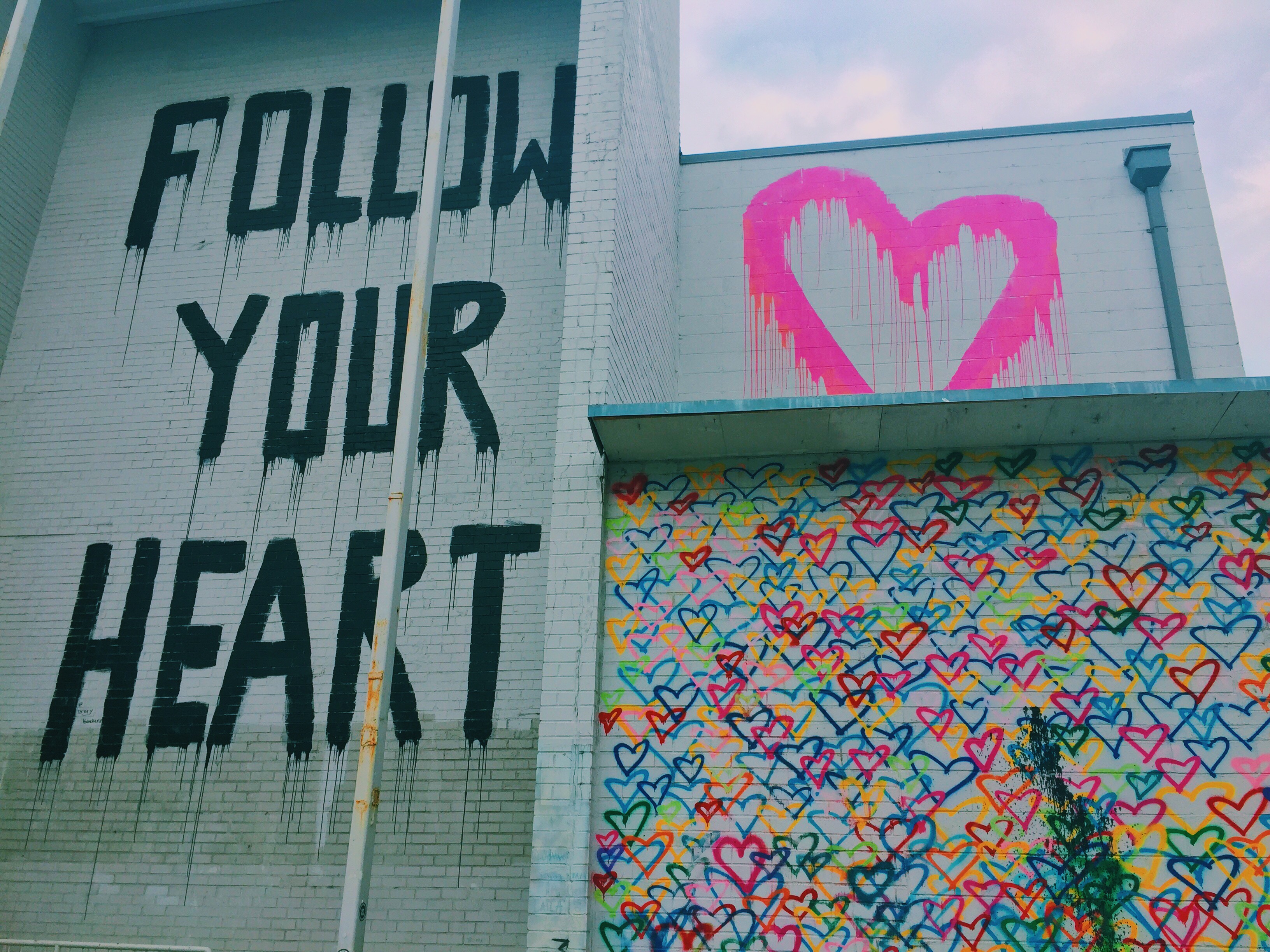 follow your heart and rainbow hearts mural