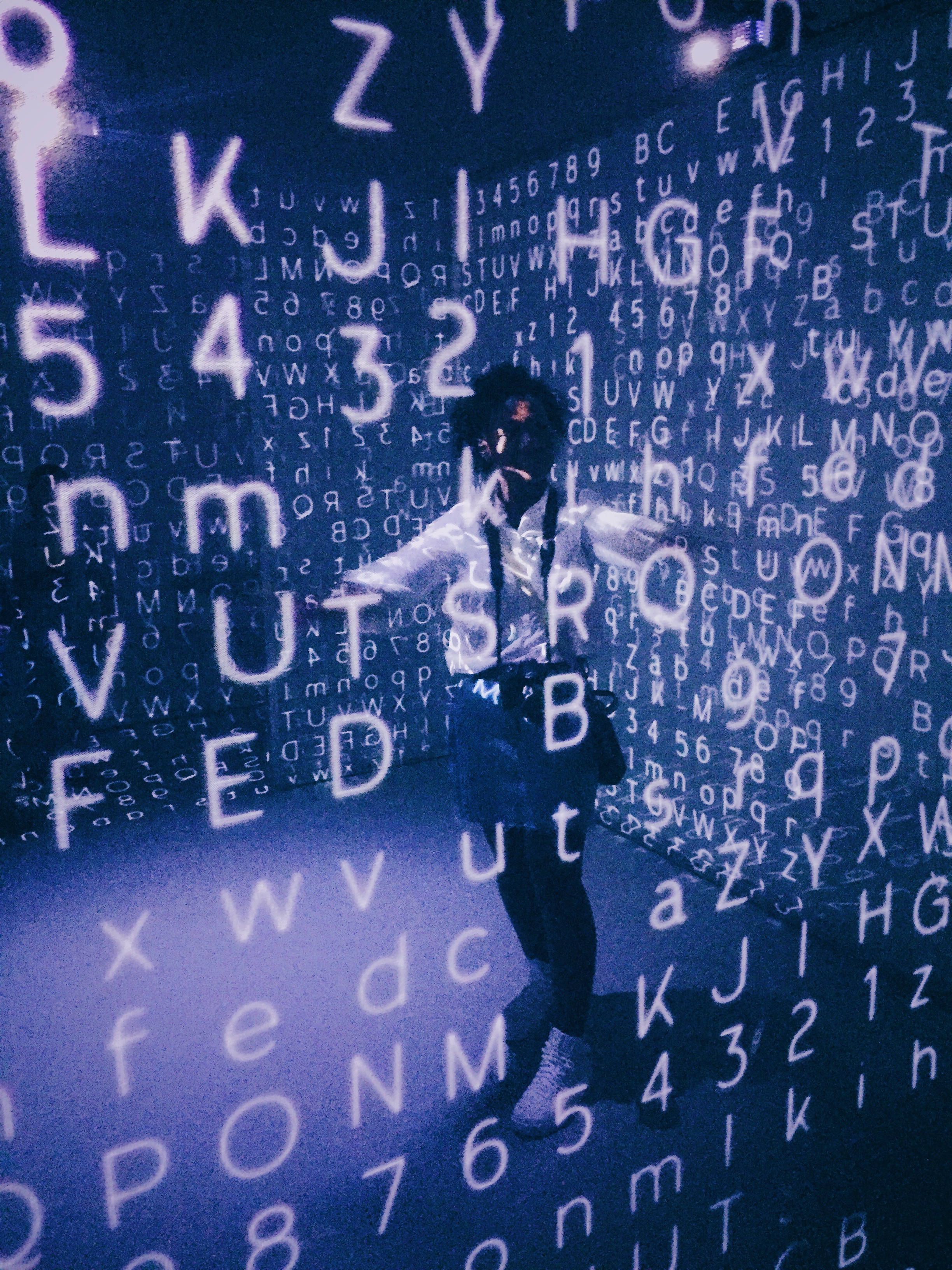 person surrounded by floating letters