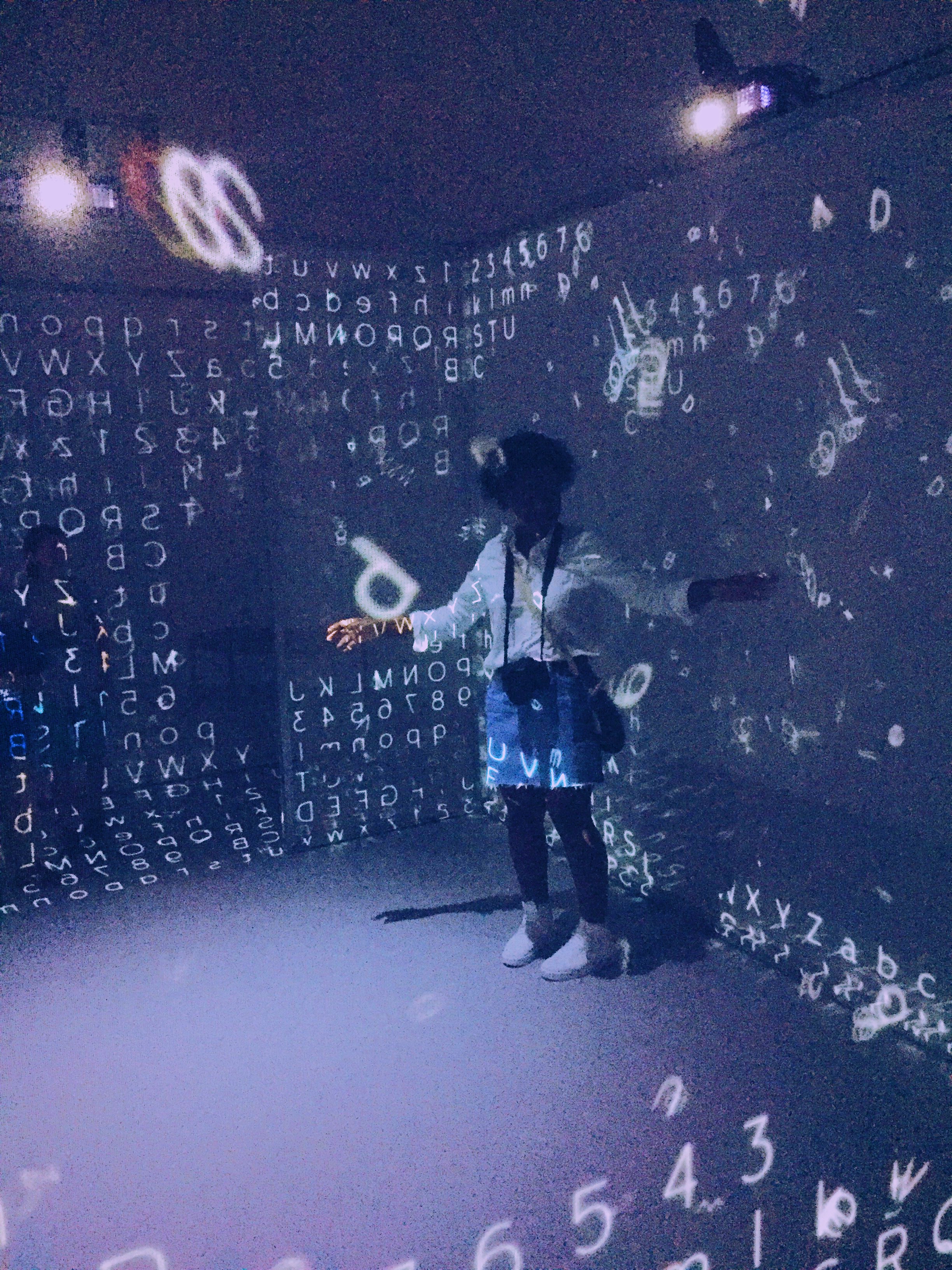 person surrounded by floating letters