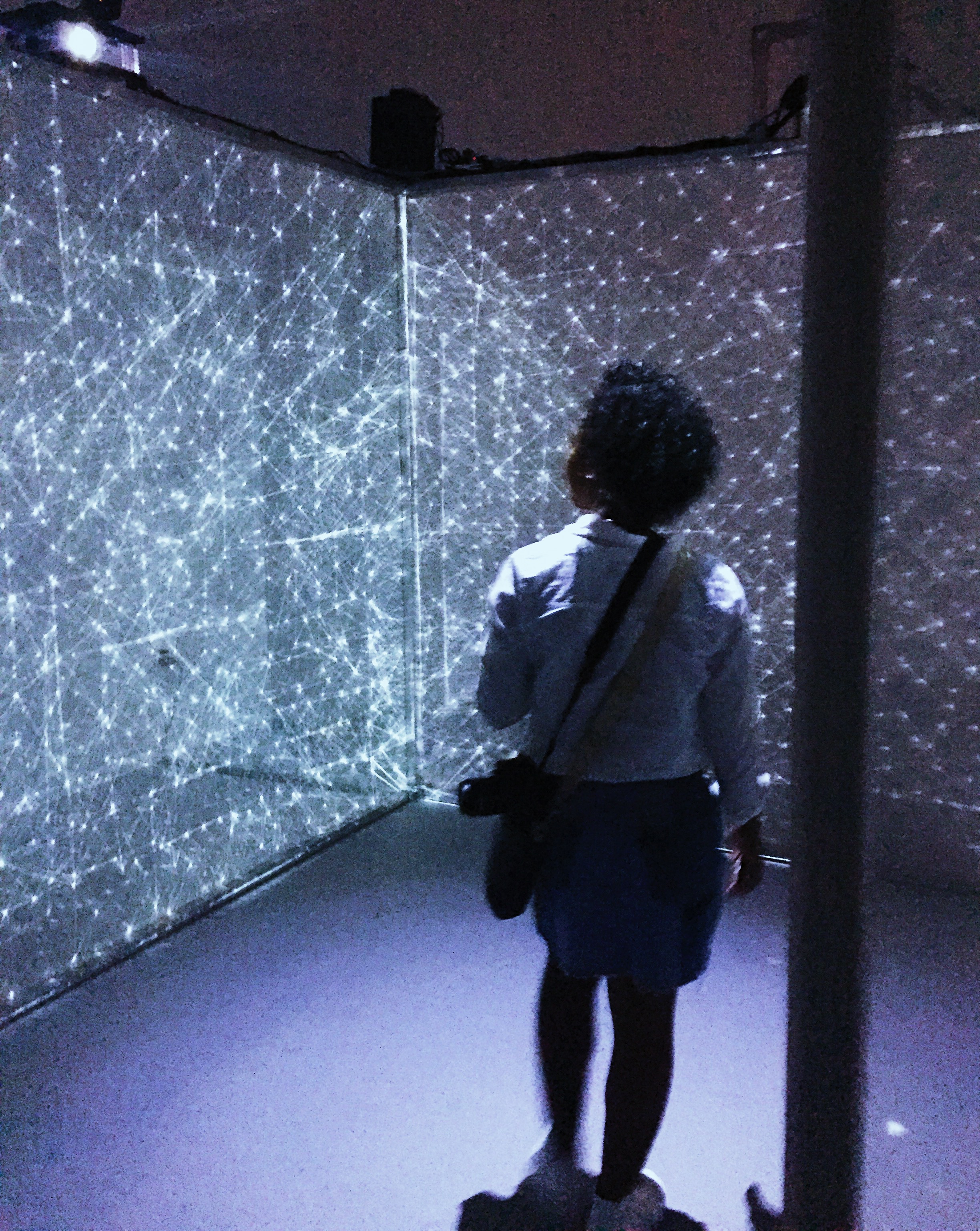 person looking at a wall of lights
