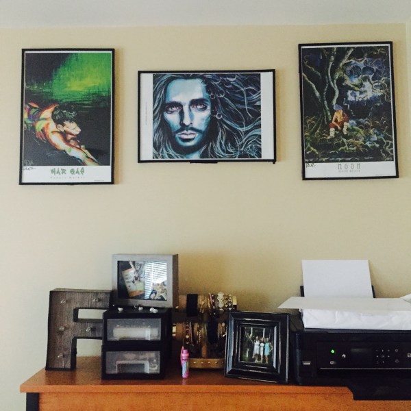 3 prints of paintings hanging above desk