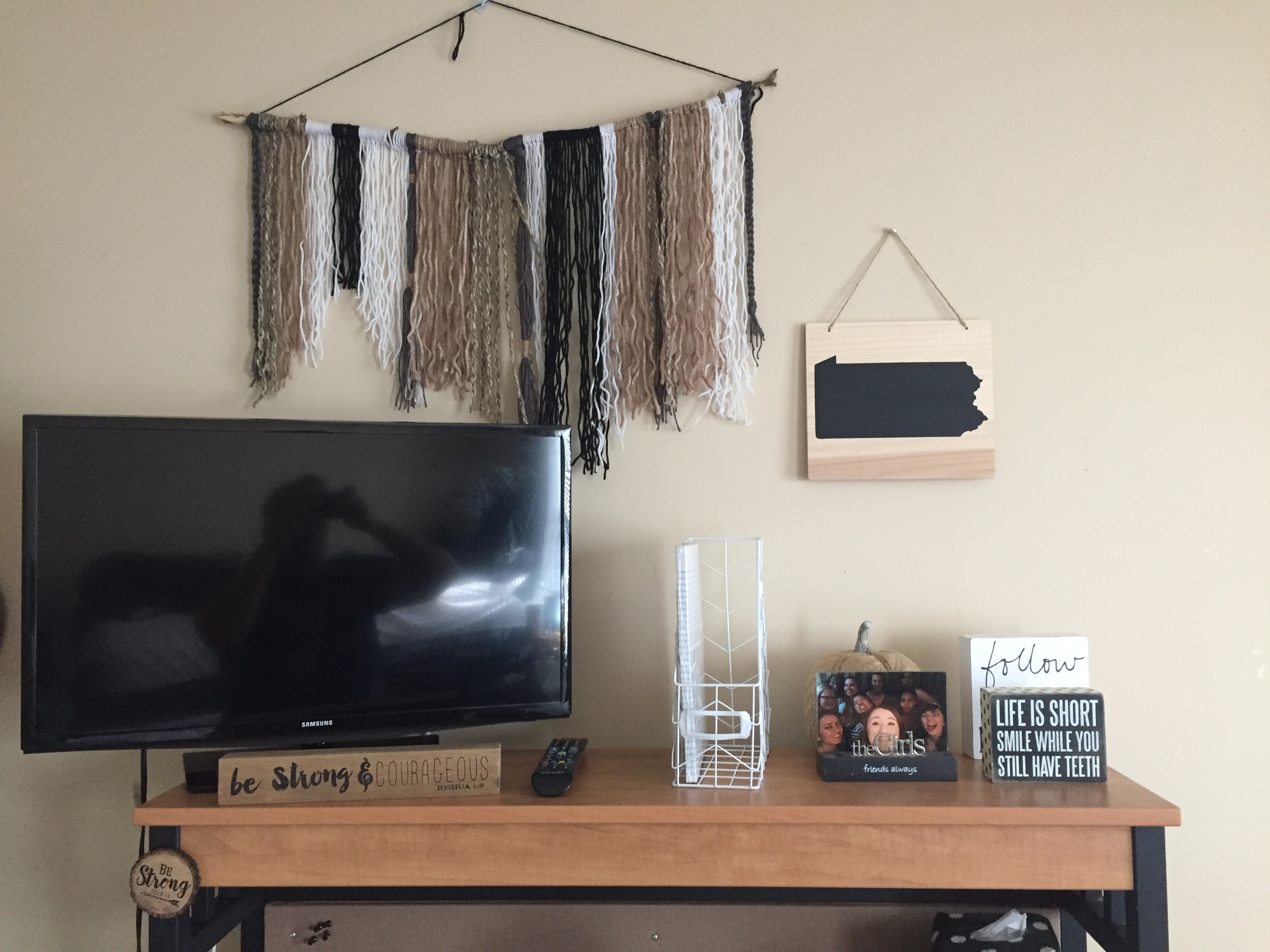 black brown and white yarn on a stick