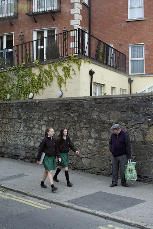 Photo of older man in contrast with two school aged girls