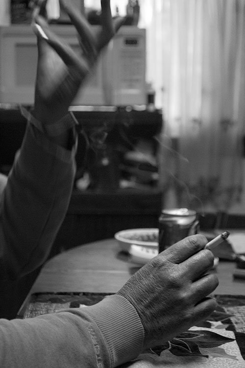 Photo of a man's hands with a cigarette