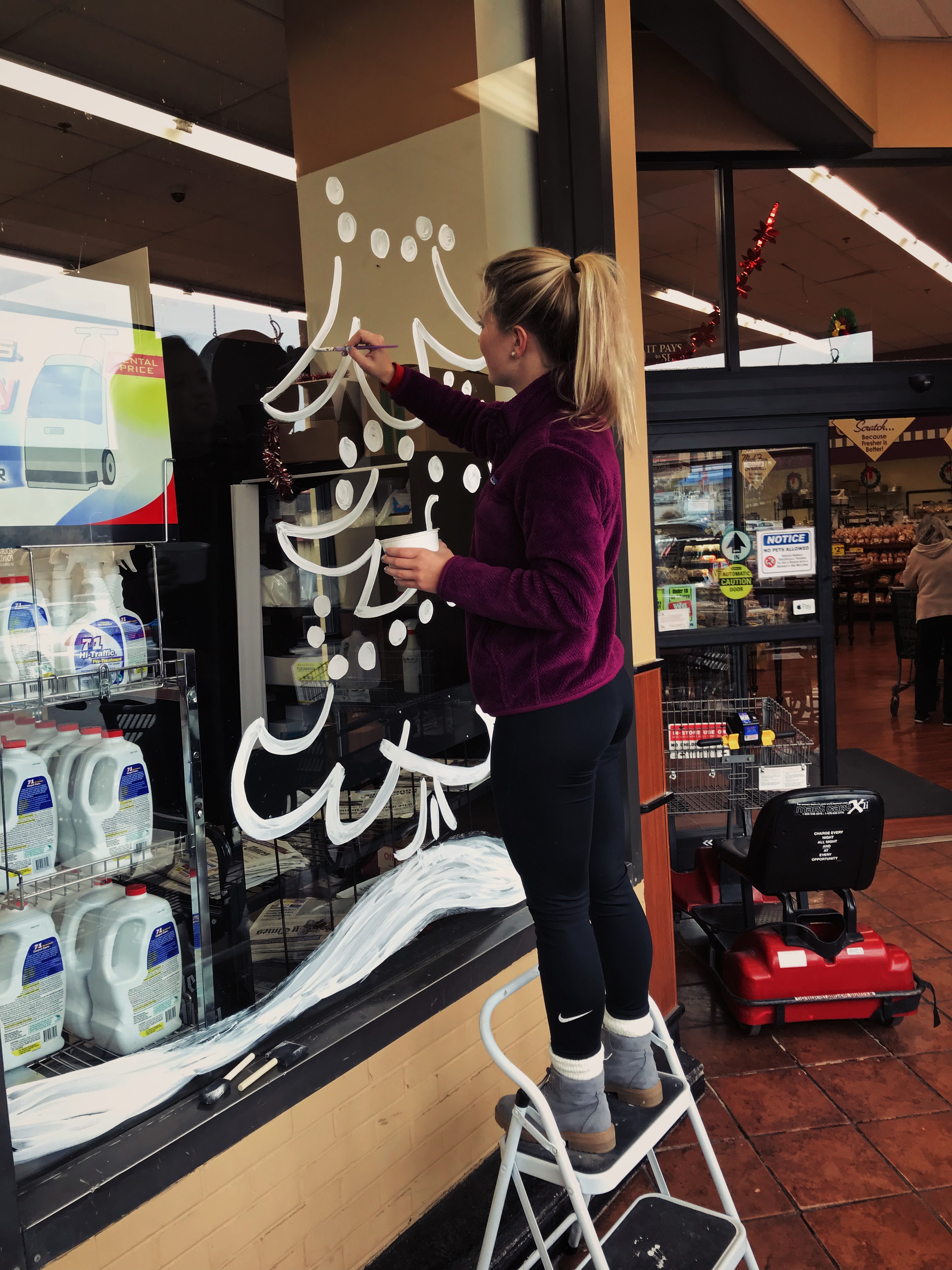 girl working on tree window design