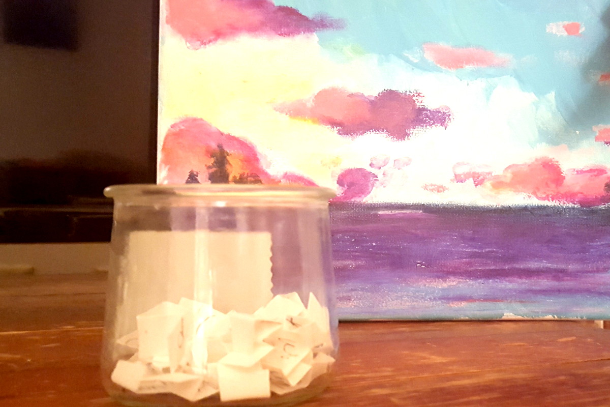 a jar with a painting behind it