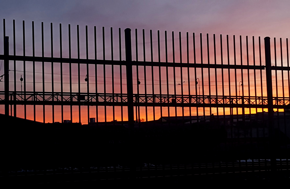 the view of the train station from the dumpsters at the mall