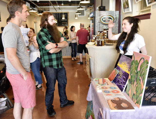 Photo of my at my table talking with the owner of the shop and the manager