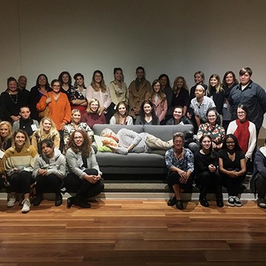 Group photo at end of forum, Richard is napping on couch