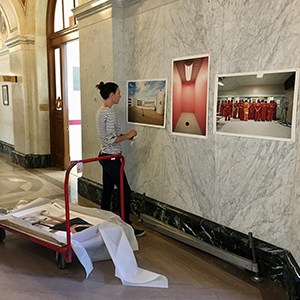 Woman hanging Richard Ross's work