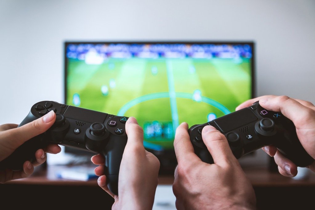 TV Screen with video game playing as people play with gaming controllers