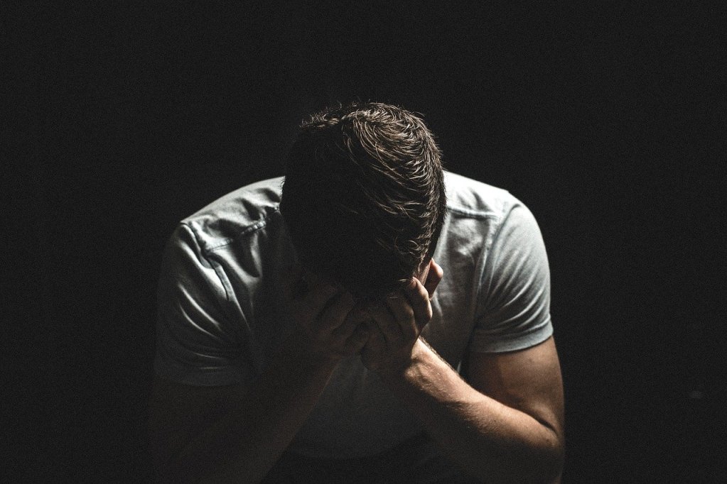 Guy Crying With His Hands On His Face  