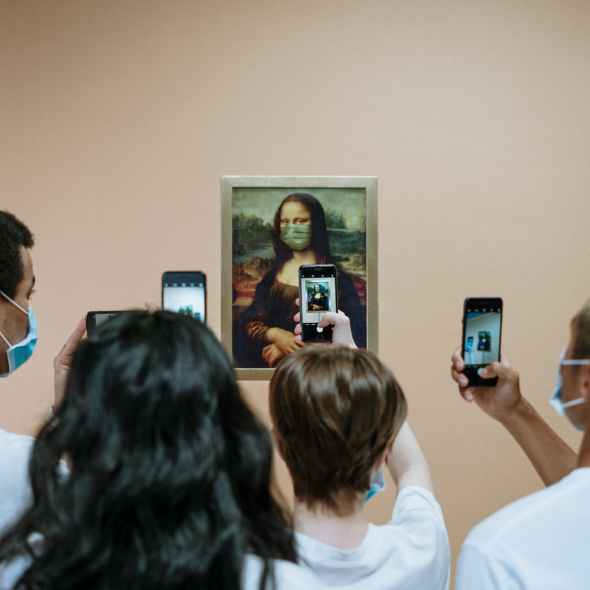 people taking picture of a painting of mona lisa with face mask