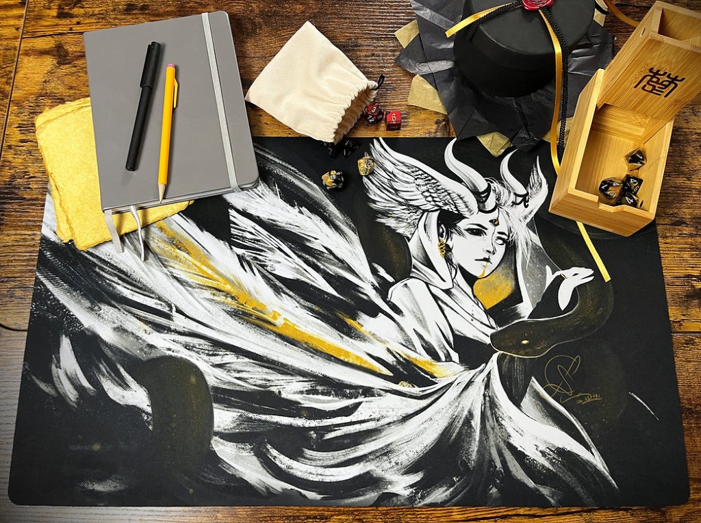 Playmat design created by Sarah Miller featuring an angel-like character.