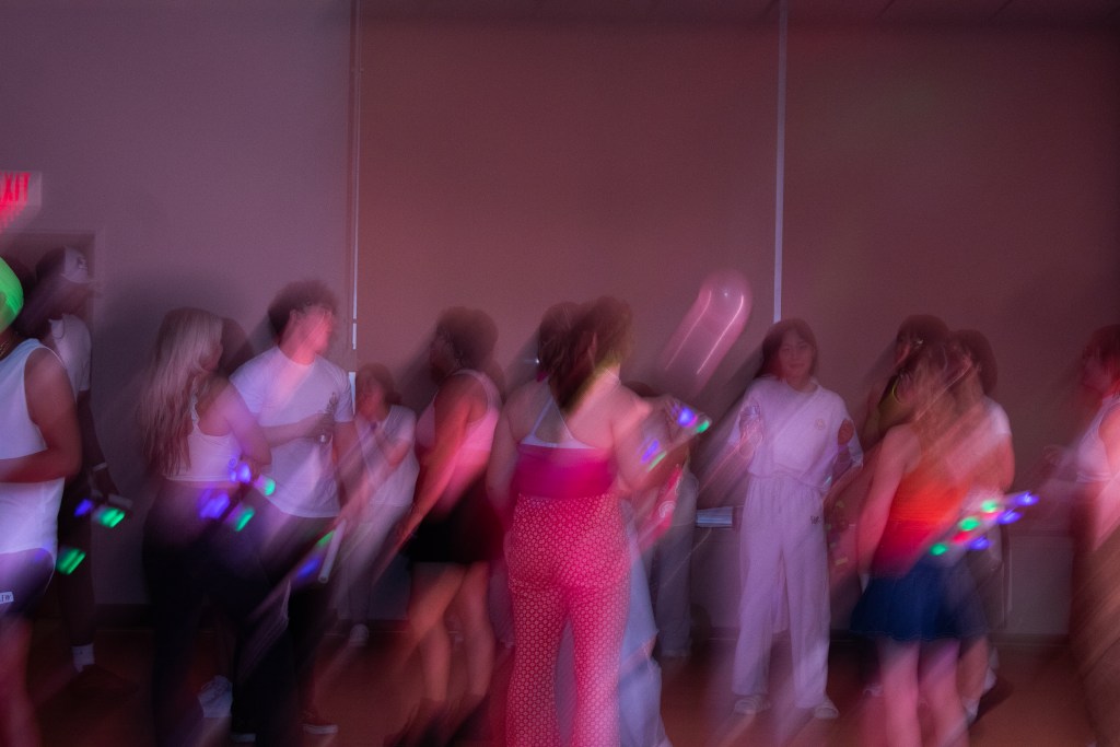 Crowd of dancing college students