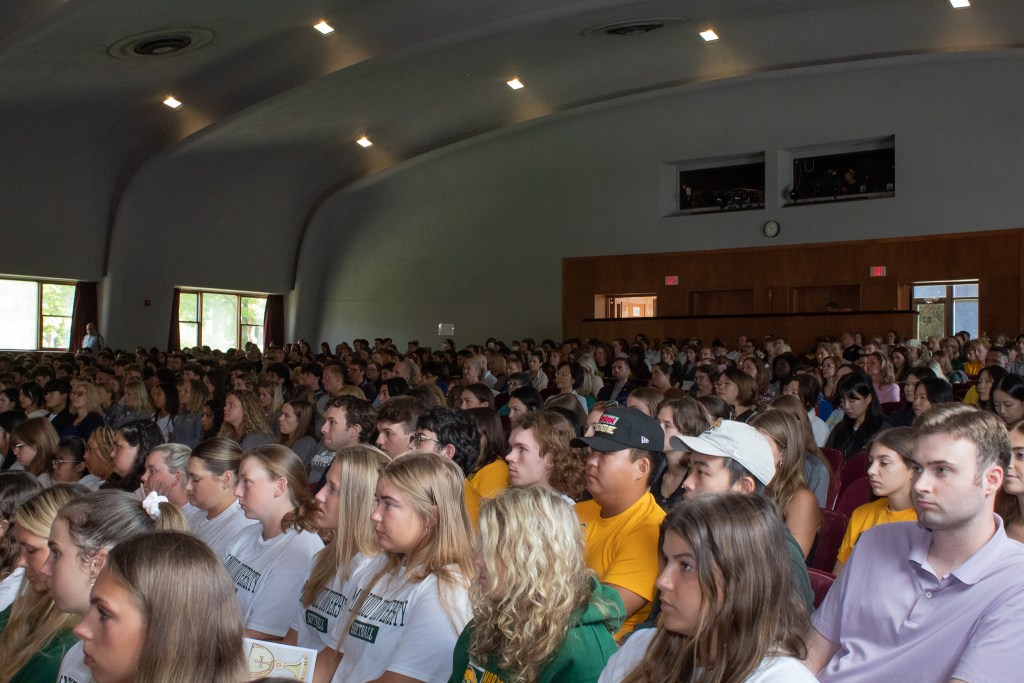 Audience members listening to speaker