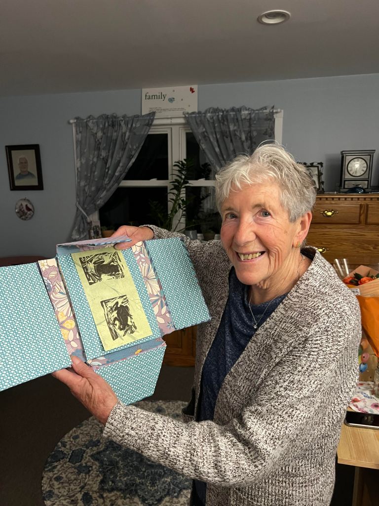 Woman holding up finished binder
