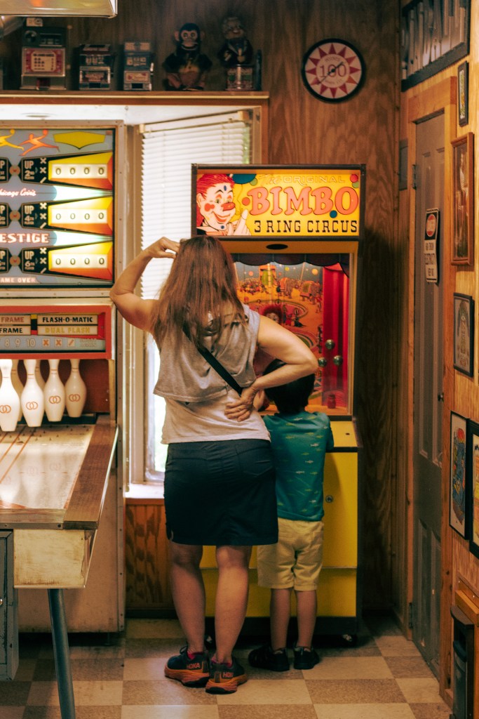 A mother and a son playing an arcade game