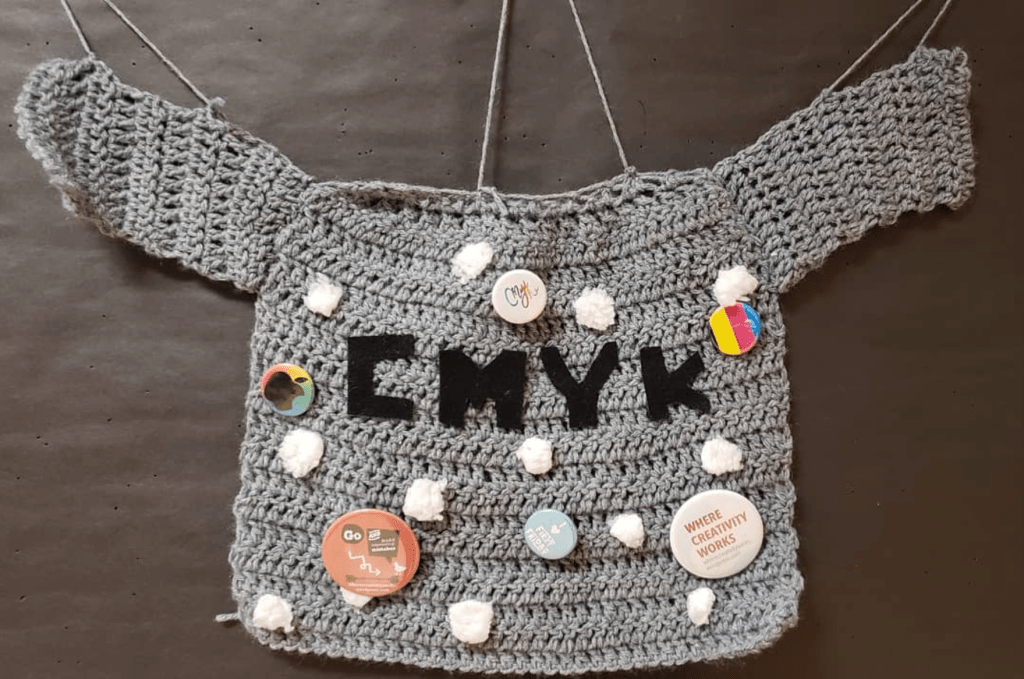 Grey sweater design that reads "CMYK"  