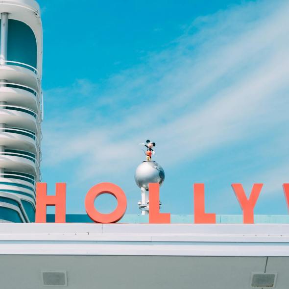 mickey mouse figure over disneys hollywood studios sign