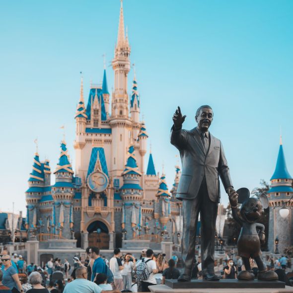 people walking around disney castle