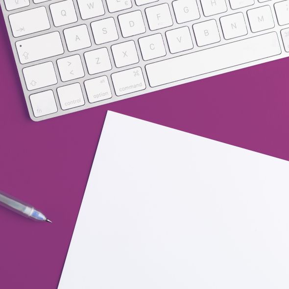 Image of keyboard, pen, and paper.
